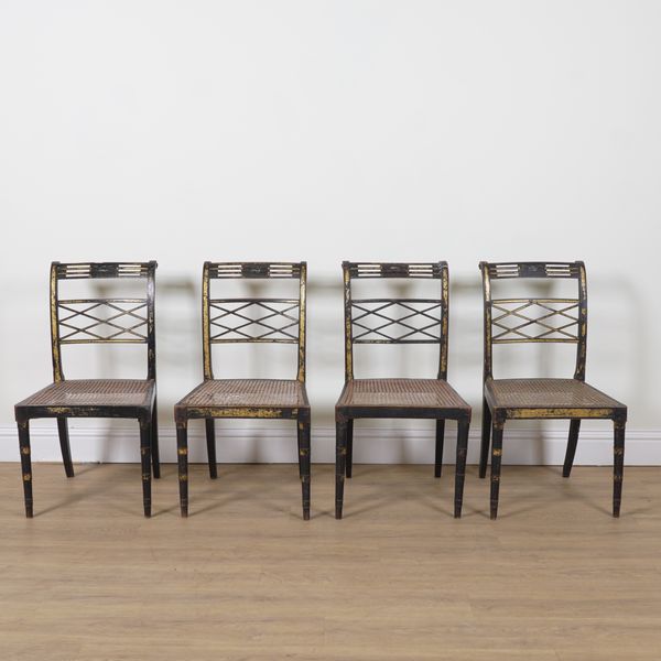 A SET OF FOUR REGENCY EBONISED GILT DECORATED CANE SEATED CHAIRS (4)