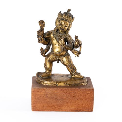 A TIBETAN GILT- BRONZE FIGURE OF A DHARMAPALA (2)