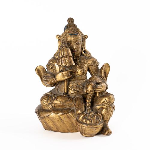 A SINO-TIBETAN GILT-BRONZE FIGURE OF KUBERA