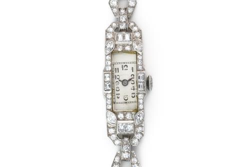 A LADY'S PLATINUM AND DIAMOND COCKTAIL BRACELET WRISTWATCH