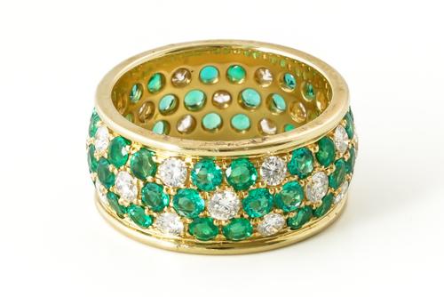 A GOLD, EMERALD AND DIAMOND FULL ETERNITY RING