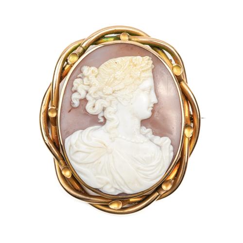 A VICTORIAN GILT METAL MOUNTED OVAL SHELL CAMEO BROOCH