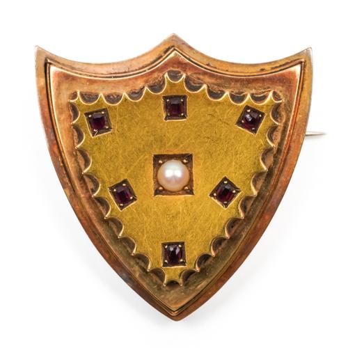 A VICTORIAN GOLD, HALF PEARL AND RUBY SHIELD SHAPED BROOCH