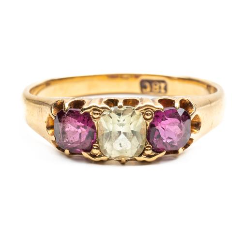 A GOLD, CHRYSOLITE AND GARNET THREE STONE RING