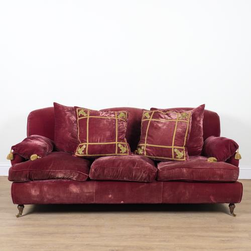 A MODERN ROUGE VELVET UPHOLSTERED TRIPLE HUMP BACK SOFA