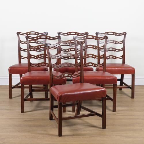 A SET OF SIX GEORGE III MAHOGANY PIERCED WAVY LADDER BACK DINING CHAIRS (6)