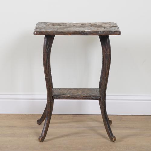 LIBERTYS; AN EARLY 20TH CENTURY FOLIATE CARVED TWO TIER OCCASIONAL TABLE