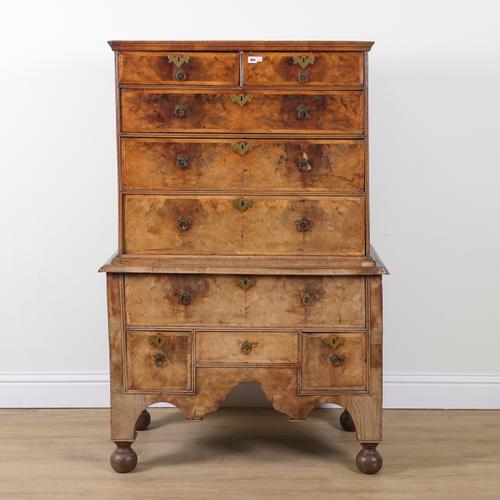 AN EARLY 18TH CENTURY CROSS BANDED FIGURED WALNUT CHEST ON STAND
