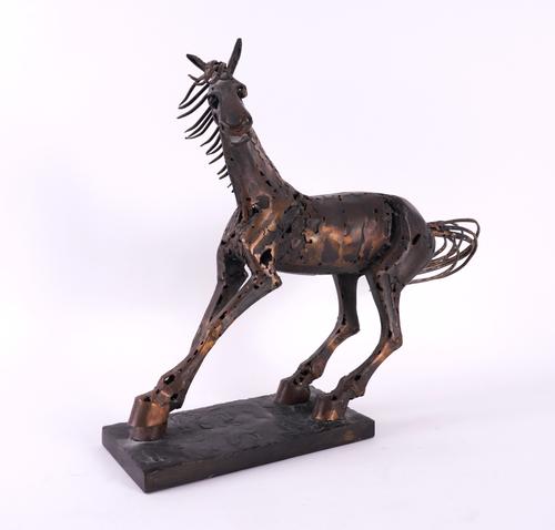 A PATINATED METAL ALLOY SCULPTURE OF A HORSE