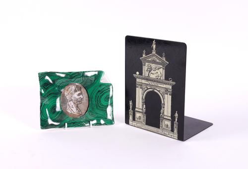 FORNASETTI MILANO: A FAUX MALACHITE DECORATED ASH TRAY AND A TOLE BOOKEND (2)