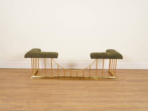 A LACQUERED BRASS AND SUEDE UPHOLSTERED CLUB FENDER