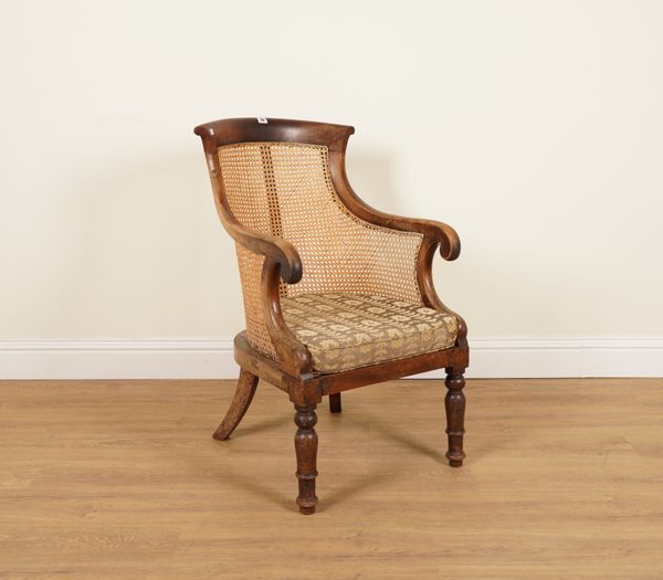 A REGENCY MAHOGANY FRAMED LIBRARY BERGERE CHAIR