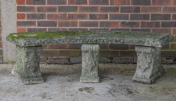 A RECONSTITUTED  STONE CONCAVE GARDEN BENCH