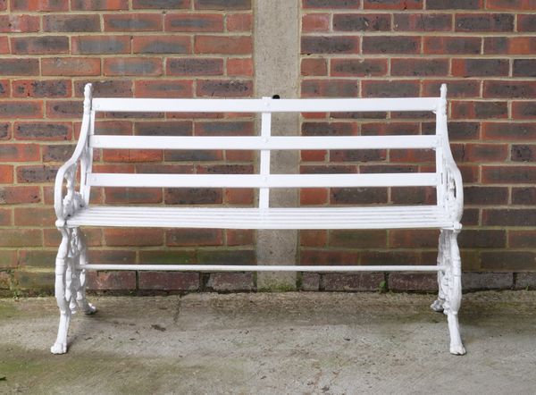 A WHITE PAINTED CAST IRON GARDEN BENCH