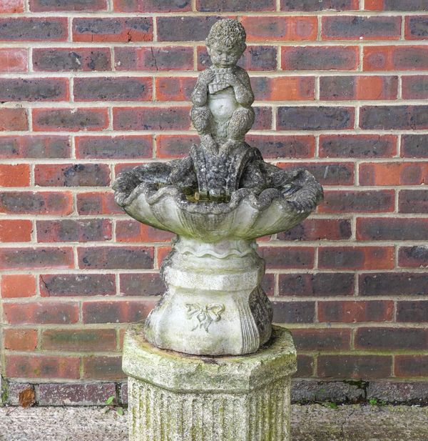 A RECONSTITUTED STONE SHELL SHAPED BIRD BATH