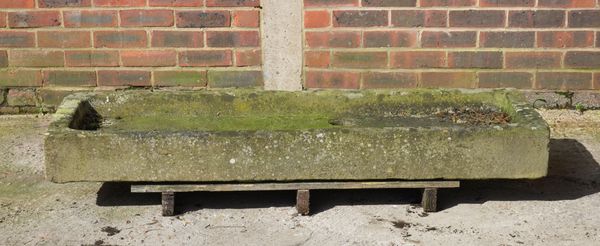 A SHALLOW RECTANGULAR CARVED STONE TROUGH