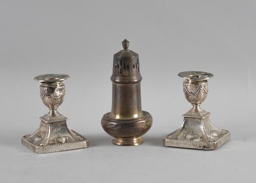 A PAIR OF SILVER CANDLESTICKS AND A SILVER SUGAR CASTER (3)