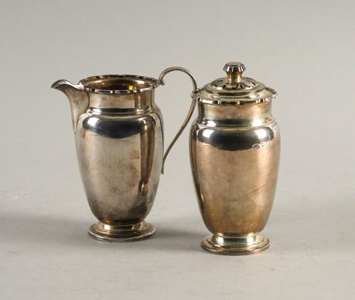 A SILVER SUGAR CASTER AND A SILVER MILK JUG (2)