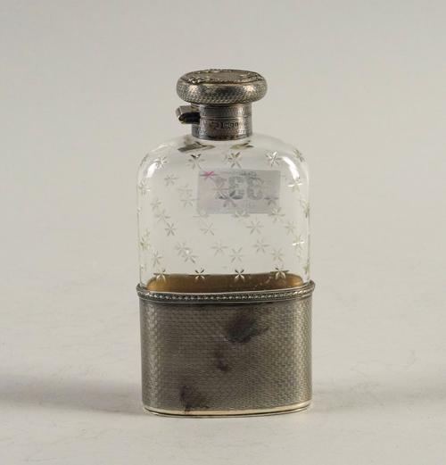 A SILVER MOUNTED GLASS SPIRIT FLASK