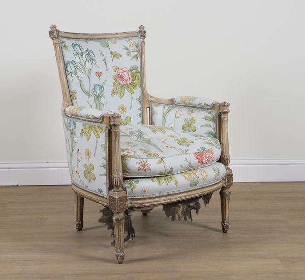 A LOUIS XVI STYLE CREAM AND PARCEL GILT FRAMED EASY ARMCHAIR