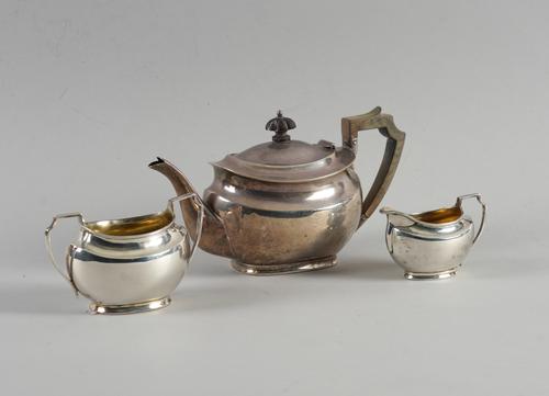 A SILVER THREE PIECE TEA SET