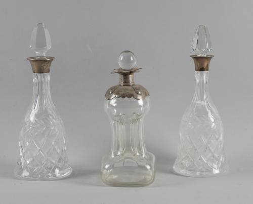 THREE SILVER MOUNTED GLASS DECANTERS (3)