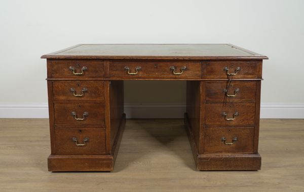 A LATE 19TH CENTURY OAK NINE DRAWER PEDESTAL DESK