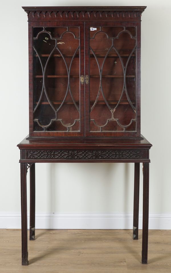 A GEORGE III AND LATER MAHOGANY TWO DOOR DISPLAY CABINET ON STAND