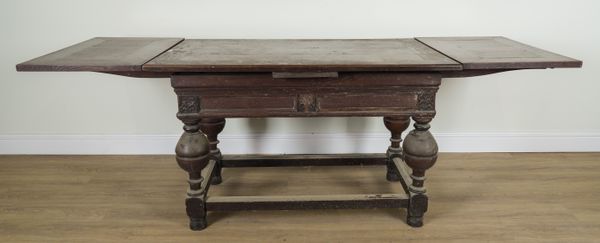 A 17TH CENTURY STYLE OAK DRAWLEAF EXTENDING TABLE