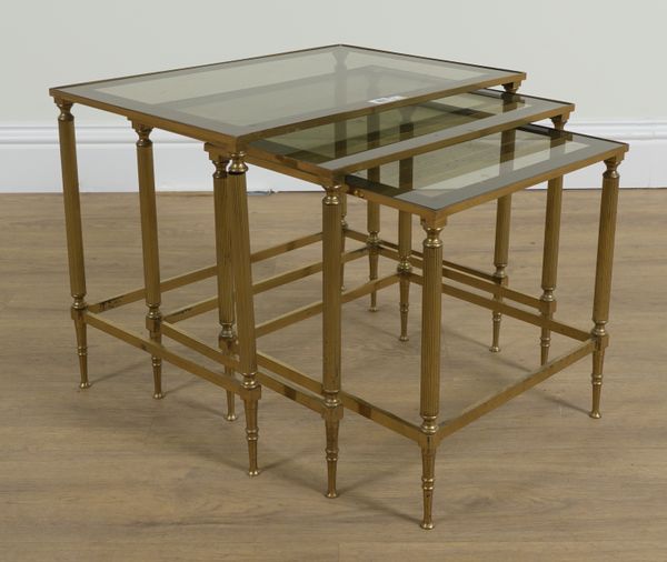 A BRASS AND GLASS NEST OF THREE TABLES