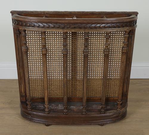 A LATE 19TH CENTURY OAK AND BERGERE BOWFRONT STICK STAND
