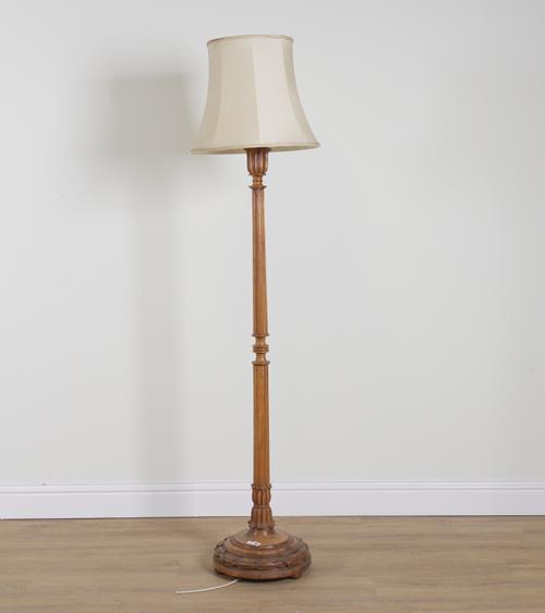 AN EARLY 20TH CENTURY FRENCH CARVED WALNUT STANDARD LAMP