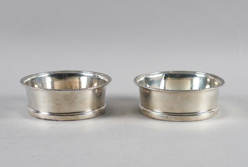 A PAIR OF SILVER AND FACETED GLASS COASTERS (2)