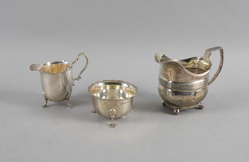 A SILVER MILK JUG AND MATCHING SUGAR BOWL AND ANOTHER SILVER MILK JUG (3)