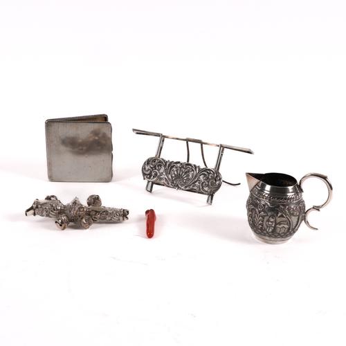 A SILVER CALENDAR STAND, A RATTLE, A CIGARETTE CASE AND AN ASIAN JUG (4)
