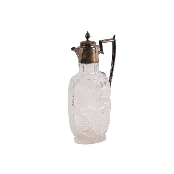 A LATE VICTORIAN SILVER MOUNTED FACETED GLASS CLARET JUG