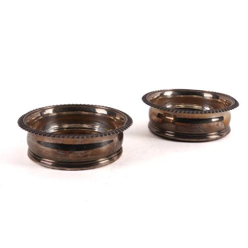 A PAIR OF GEORGE III SILVER MOUNTED BOTTLE COASTERS (2)