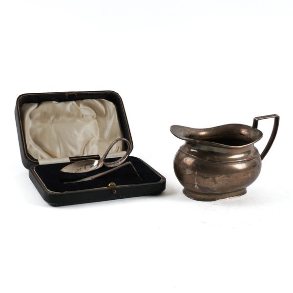 A SILVER MILK JUG AND A SILVER CHRISTENING SET (2)