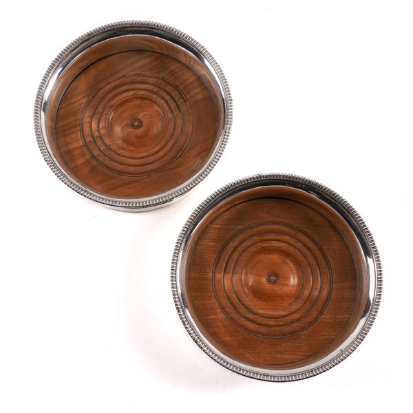 A PAIR OF GEORGE III SILVER MOUNTED BOTTLE COASTERS (2)