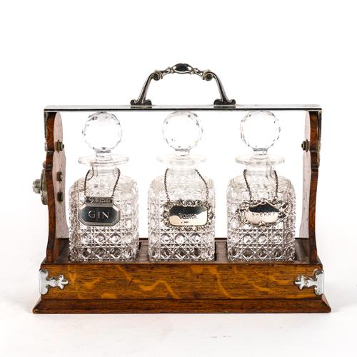 BETJEMANN'S PATENT: A THREE GLASS DECANTER OAK TANTULAS