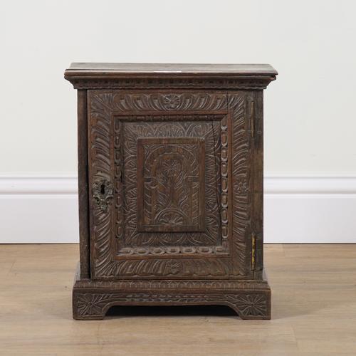 AN EARLY 18TH CENTURY LATER CARVED OAK SPICE CUPBOARD