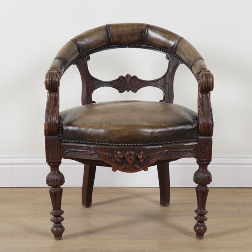 A VICTORIAN CARVED OAK FRAMED STUDDED LEATHER UPHOLSTERED TUB BACK DESK CHAIR