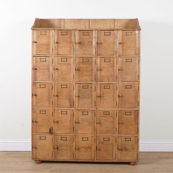 AN EARLY 20TH CENTURY PINE TWENTY-FIVE DOOR LOCKER CABINET