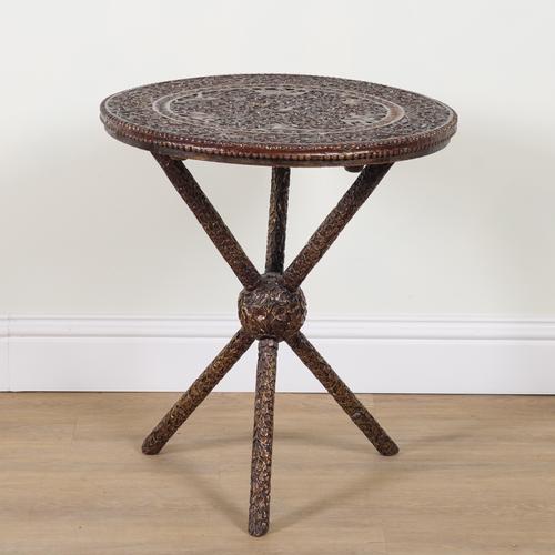 AN EARLY 20TH CENTURY BURMESE EXTENSIVELY CARVED TEAK CIRCULAR OCCASIONAL TABLE