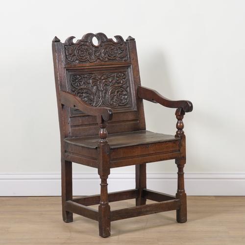 A CHARLES II OAK WAINSCOT OPEN ARMCHAIR