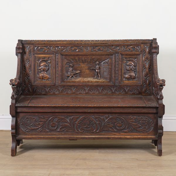 A 17TH CENTURY STYLE CARVED OAK BOX SEAT SETTLE