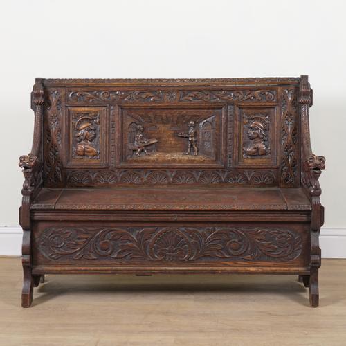 A 17TH CENTURY STYLE CARVED OAK BOX SEAT SETTLE
