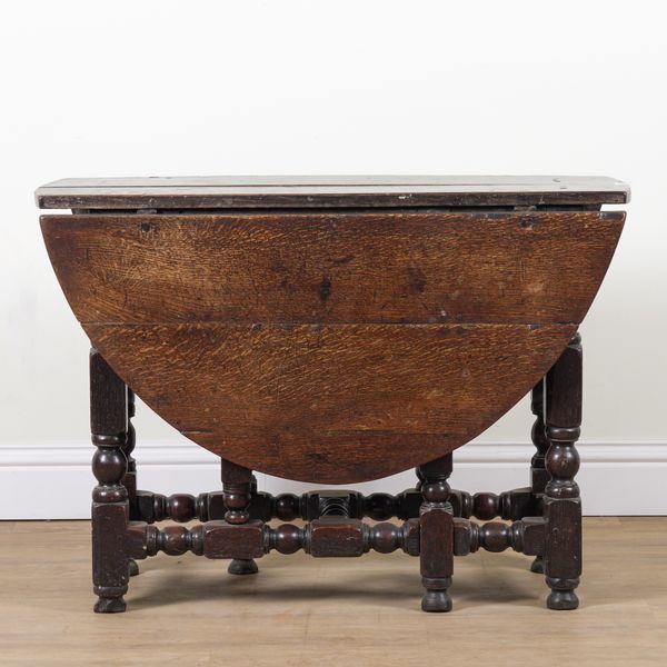 A CHARLES II OAK DROP FLAP GATELEG DINING TABLE