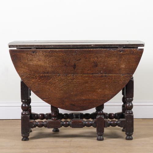 A CHARLES II OAK DROP FLAP GATELEG DINING TABLE