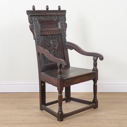 A CHARLES II OAK WAINSCOT OPEN ARMCHAIR